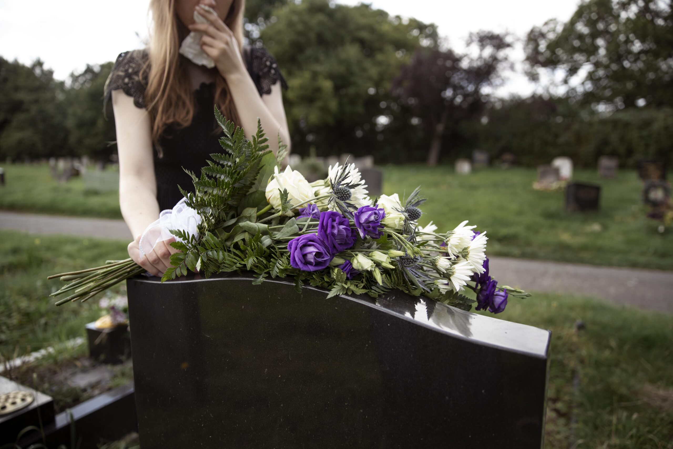 woman visiting grave loved one scaled